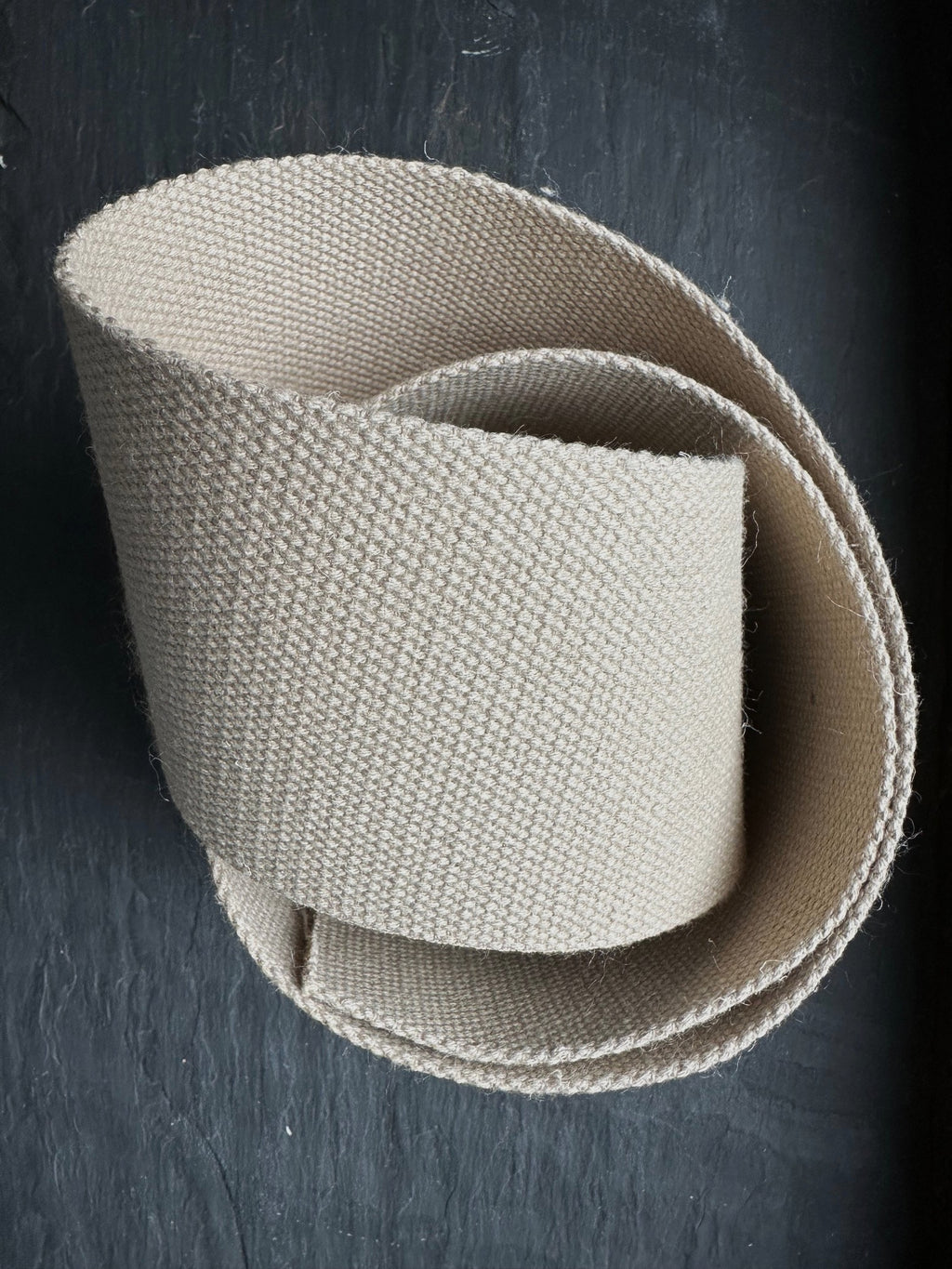 woven hemp webbing wide piece on dark slate surface