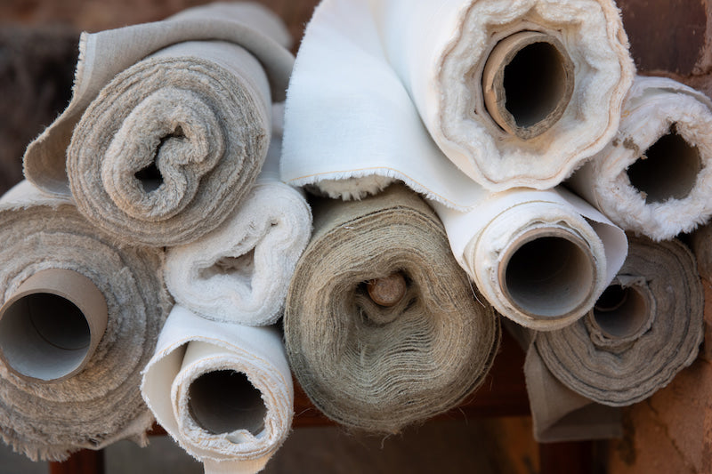 Close-up of rolled-up hemp fabric with a textured surface.