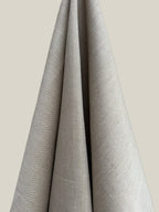 Cairn natural hemp twill fabric draped over a neutral background