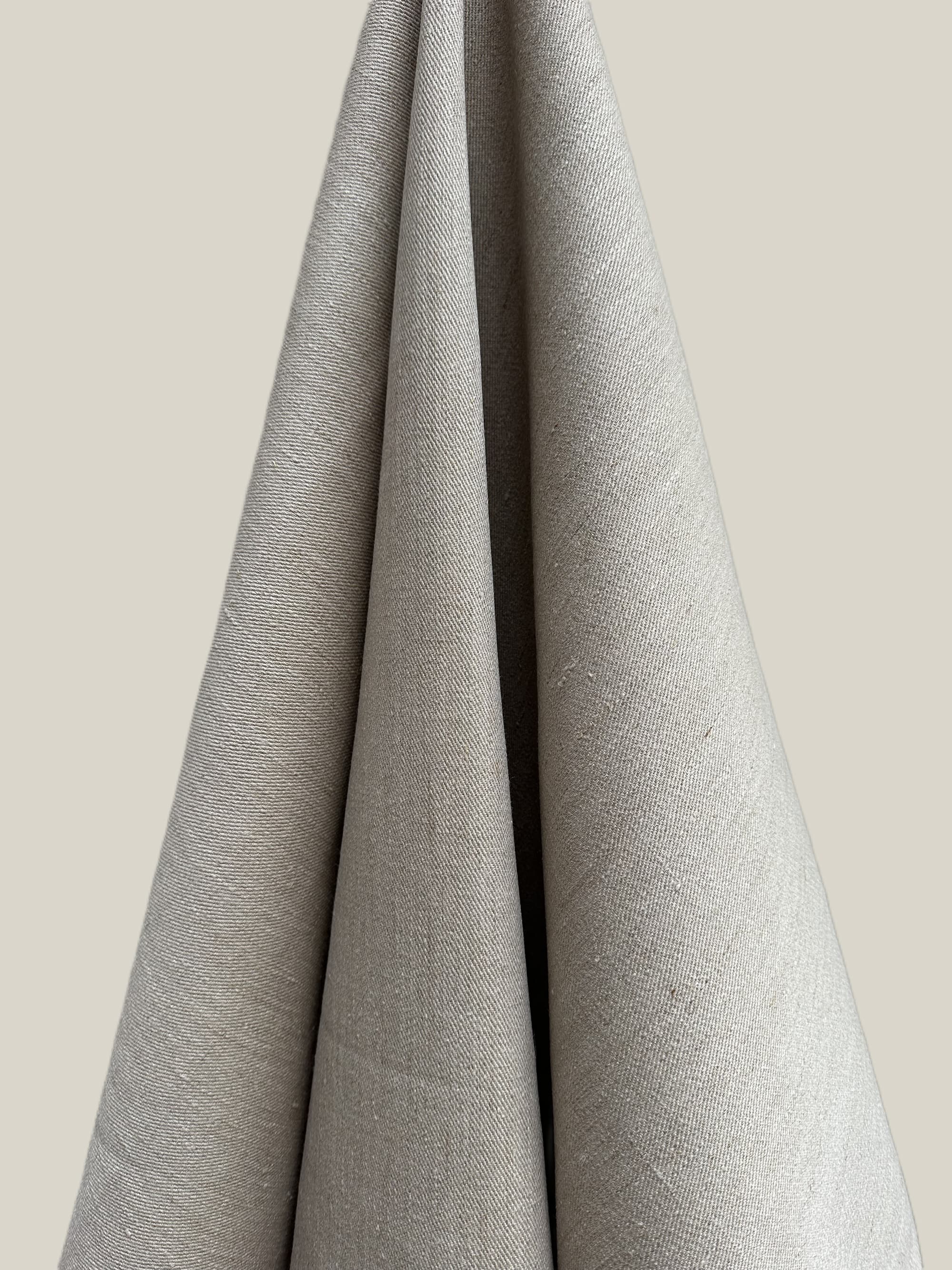 Cairn natural hemp twill fabric draped over a neutral background
