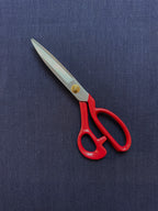 Red-handled scissors on a Cairn indigo blue hemp fabric background