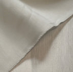 close up of satin hemp silk fabric in cream with texture