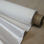 Glint satin silk hemp fabric on roll on beige carpet