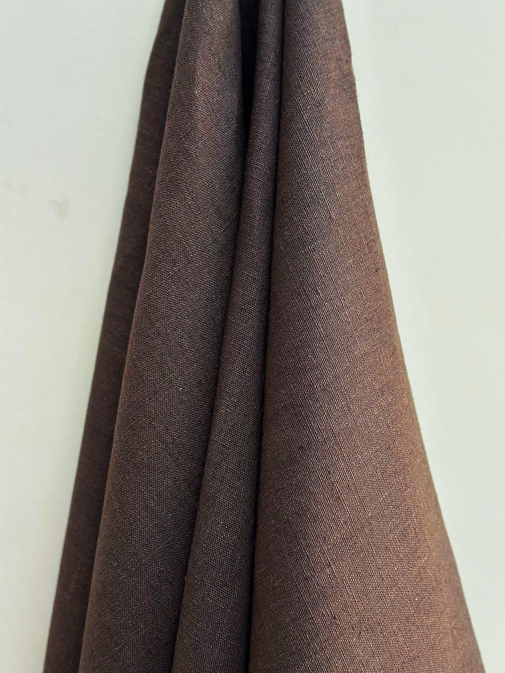 Dama Chocolate Brown hemp fabric draped against a white background