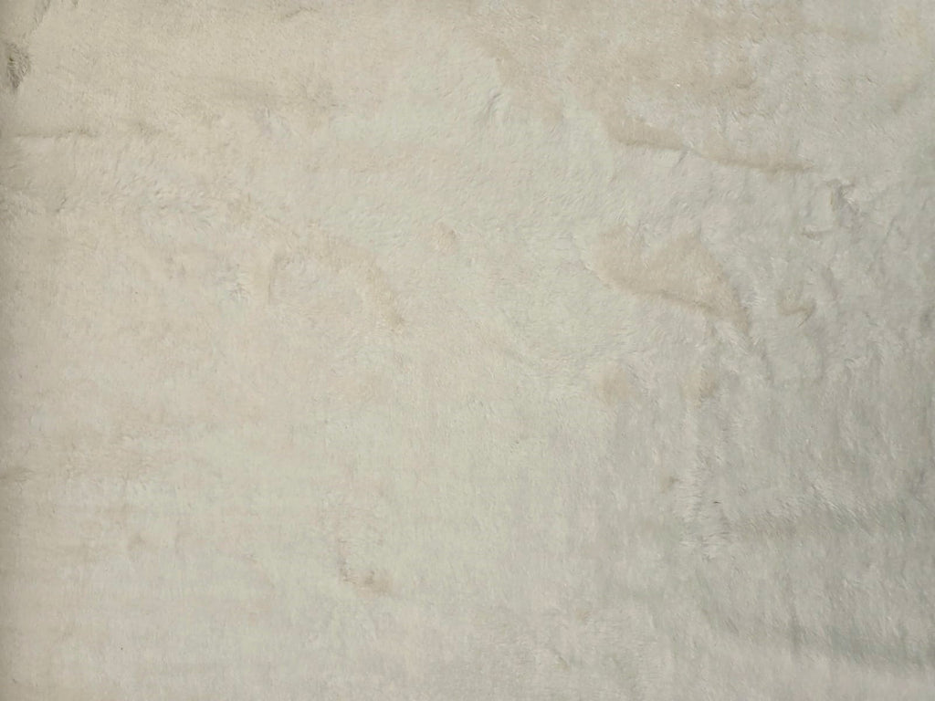 Close up Cosmos faux fur hemp fabric in cream laid flat