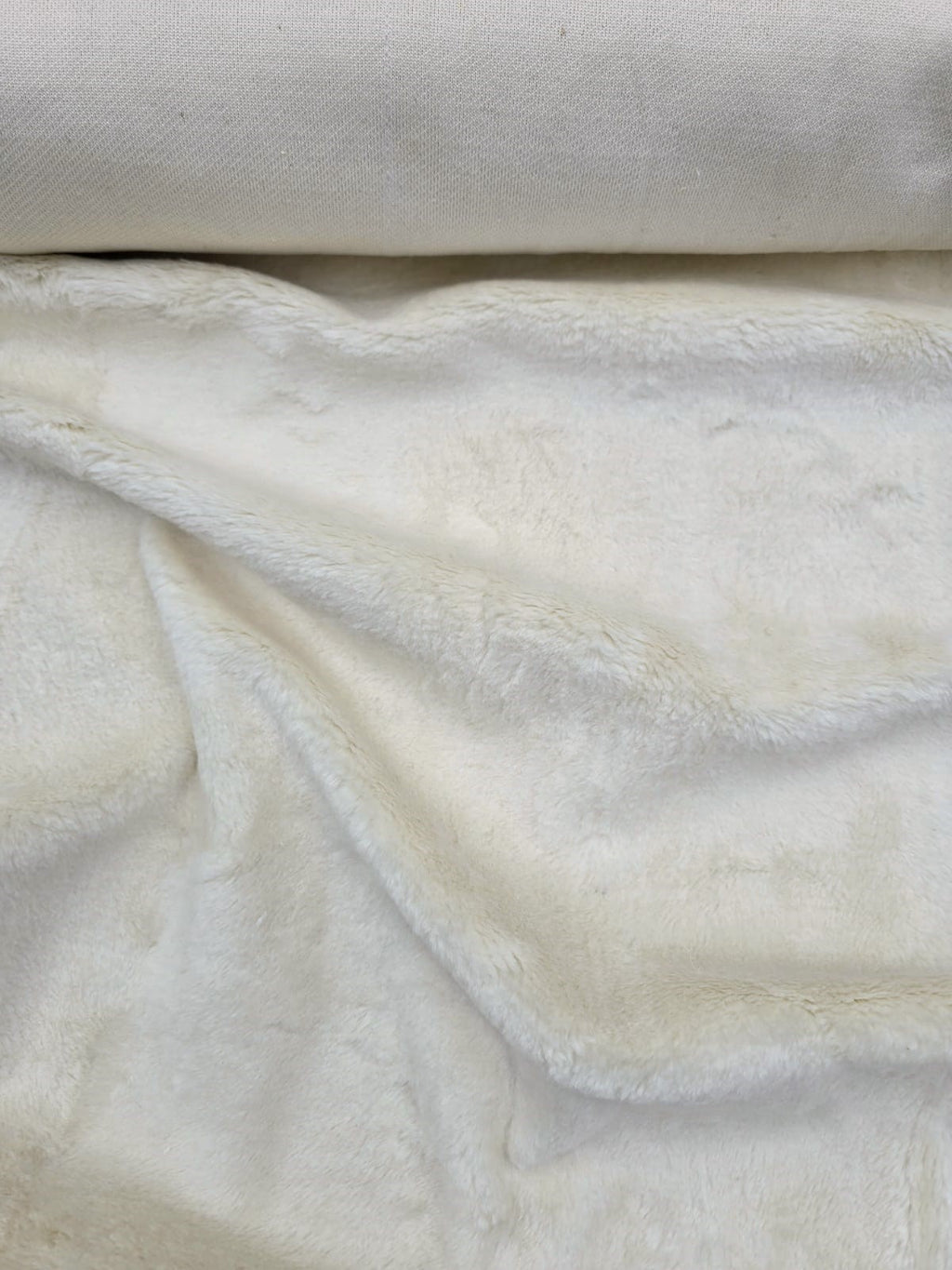 Cosmos faux fur hemp upholstery fabric rolled in cream