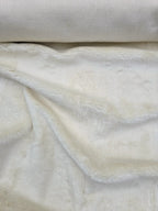 Cosmos faux fur hemp upholstery fabric rolled in cream