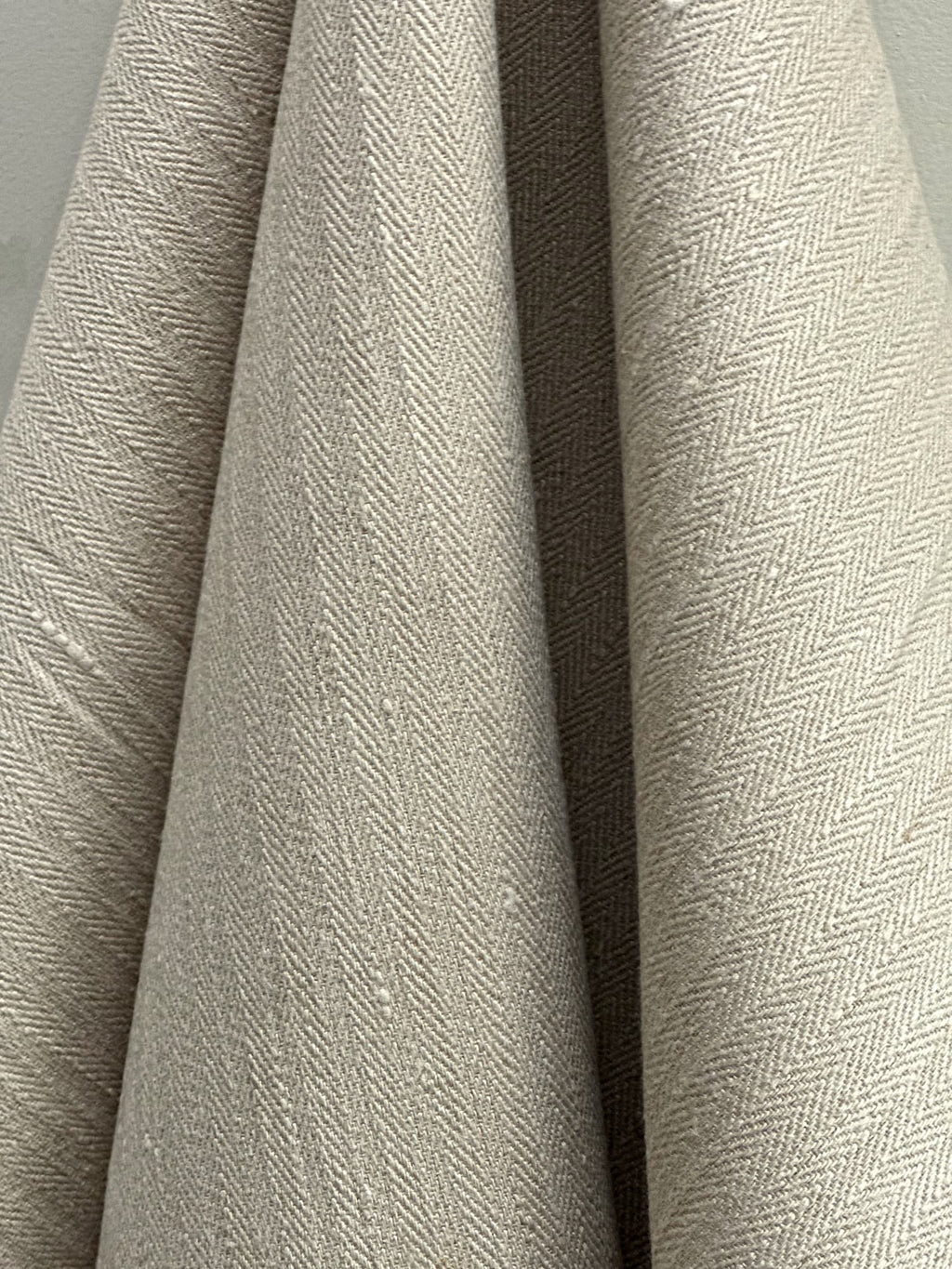 Close-up of textured herringbone hemp fabric Hampa with a neutral color palette