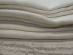 folded pile of Tarn hemp fabric in ivory