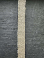 Herringbone hemp natural webbing strip on dark slate background