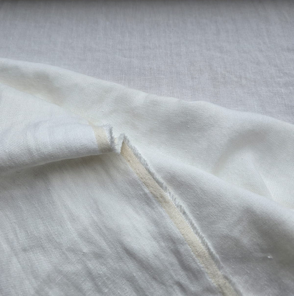 Close-up of Linden hemp fabric in white with a visible edge 