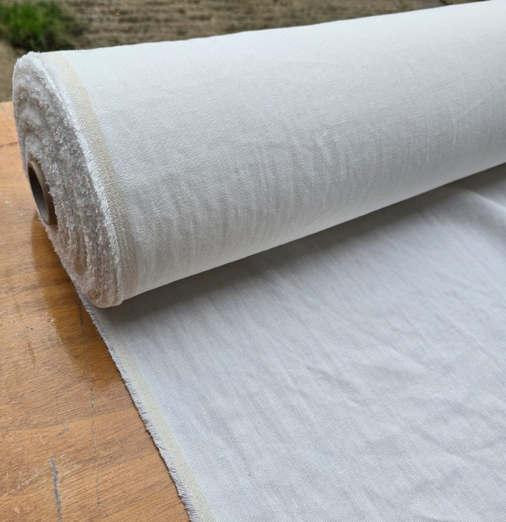 Linden hemp fabric in ivory roll on wooden table