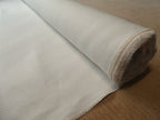 Mesa hemp and cotton canvas fabric roll against beige carpet background