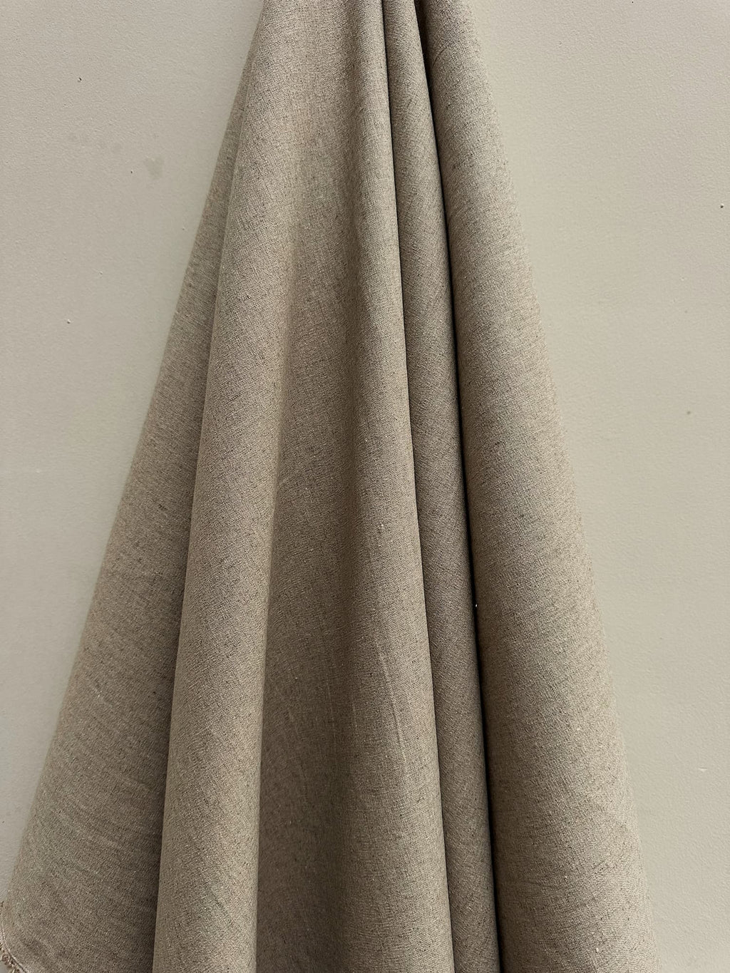 Sorrel natural hemp fabric hung against a neutral wall