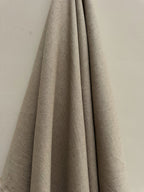 Sorrel natural hemp fabric hung against a neutral wall